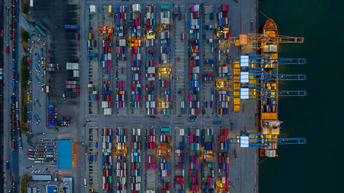 High angle view of illuminated commercial dock against buildings