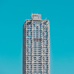 Skyscraper in the center of barcelona and blue sky in background, spain.