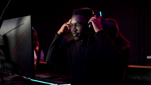 Man playing video game in darkroom