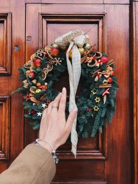 Midsection of person holding christmas tree