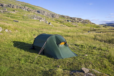 Scenic view of tent on mountain against sky