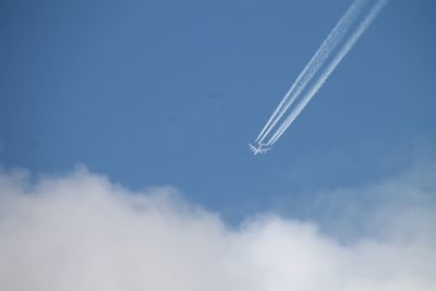 Low angle view of vapor trail against sky