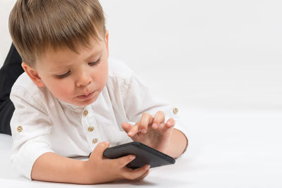 Boy looking away while using mobile phone