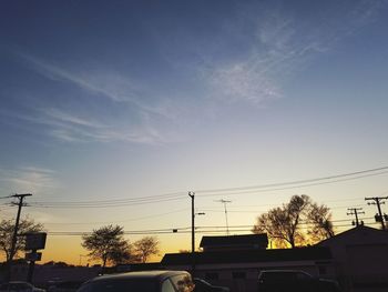 Silhouette city against sky during sunset