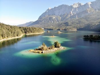 Scenic view of lake and mountains against sky