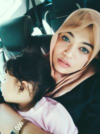 Portrait of happy woman sitting in car