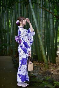 Midsection of woman standing on tree