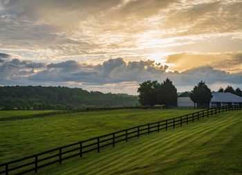 Scenic view of field against sky during sunset