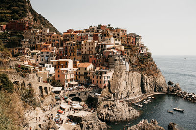 High angle view of townscape by sea against sky