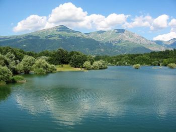 Scenic view of lake against blue sky