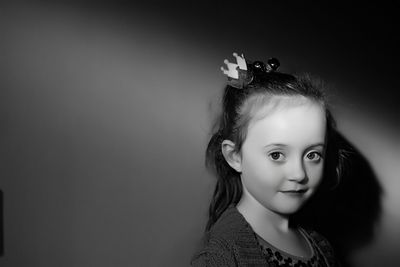 Portrait of girl against wall