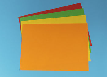 Close-up of yellow paper against blue background