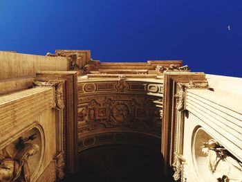 Low angle view of historic building against clear blue sky