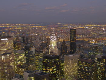 Aerial view of city lit up at night