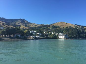 Scenic view of river against clear blue sky