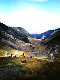People on mountain road against sky