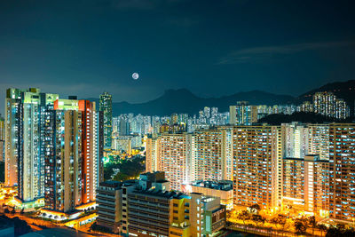 High angle view of illuminated buildings in city at night