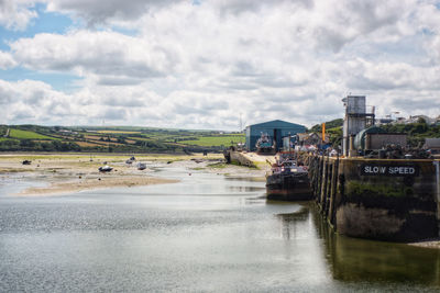 Scenic view of river against sky in city