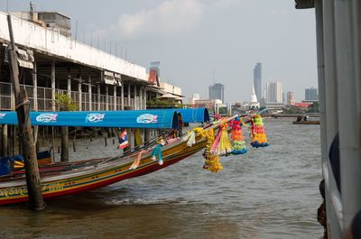 View of boats in river against buildings