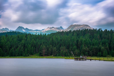 Scenic view of lake and mountains against sky