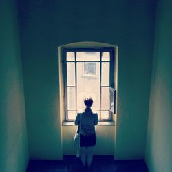 Full length of woman standing on wall