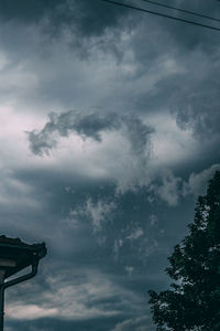 Low angle view of silhouette trees against sky