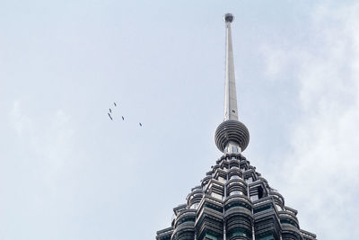 Low angle view of communications tower against sky