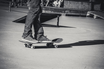 Low section of man skateboarding on skateboard