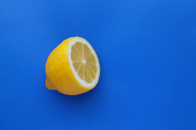 Close-up of lemon against blue background