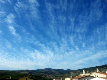 Scenic view of mountains against blue sky