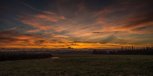 Scenic view of field against sky during sunset