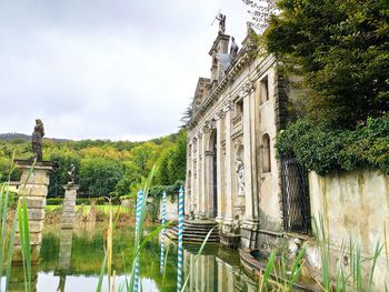 Panoramic view of building by canal against sky