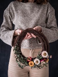 Close-up of woman holding basket of flower