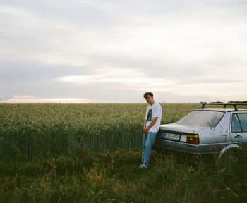 Full length of man standing on field against sky