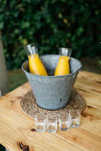 Close-up of drink in metallic bucket on table