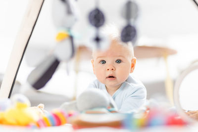 Portrait of cute baby boy with teddy bear