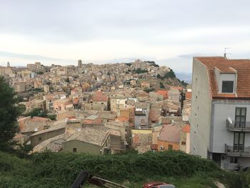 Houses in town against sky