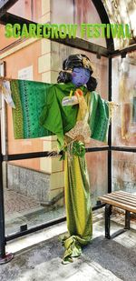 Rear view of woman standing against multi colored wall