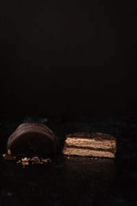 Close-up of chocolate cake against black background