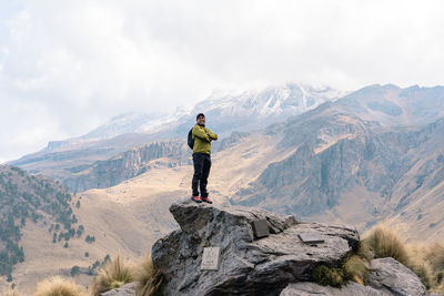 Rear view of man standing on mountain