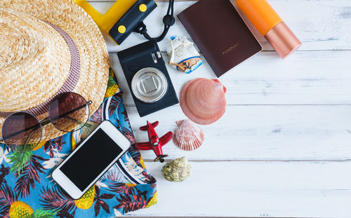 Directly above shot of travel equipment on wooden table