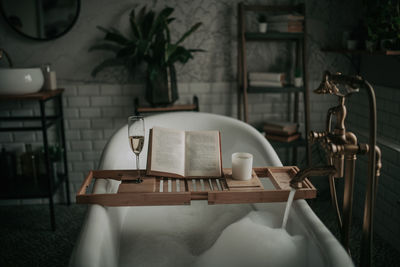 Luxury interior of big bathroom at modern african style with oval bathtub in natural lighting