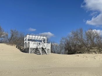 Scenic view of beach against clear blue sky