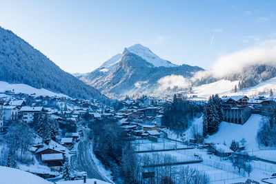 Scenic view of snowcapped mountains and houses
