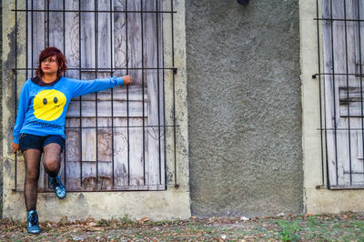 Portrait of boy standing on wall