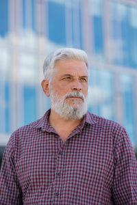 An adult male gray-haired european senior businessman. focused european man