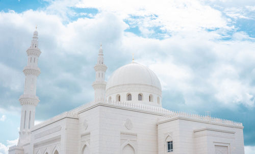 Low angle view of building against cloudy sky