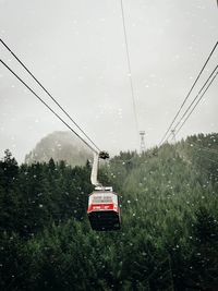 Overhead cable car on road during rainy season