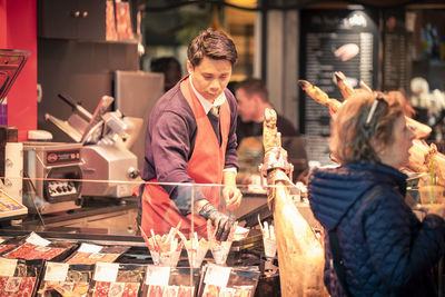 People standing by display at store