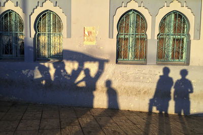 Shadow of people on building wall